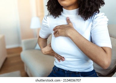 African American Woman hand checking lumps on her breast for signs of breast cancer. woman is suffering from pain in the breast. BSE or Breast Self-Exam. Guidelines to check for cancer. - Shutterstock ID 2134036707