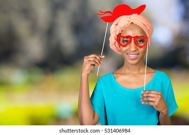 African american woman having fun with photo props - Powered by Shutterstock