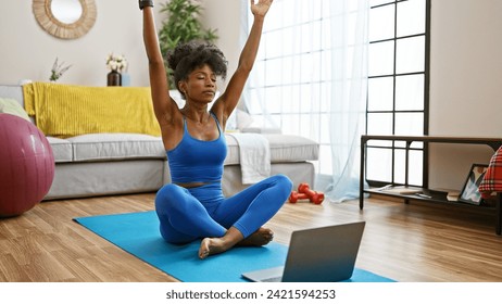 African american woman having online yoga class at home - Powered by Shutterstock