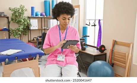 African american woman healthcare worker using tablet in a rehab clinic interior. - Powered by Shutterstock