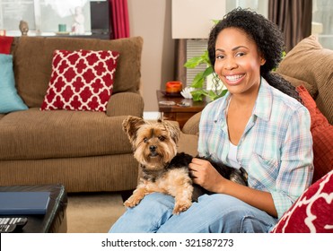 African American Woman And Her Dog At Home