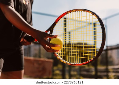 African american woman hold racket and yellow green ball, playing tennis match on clay court surface on weekend free time sunny day. Female player ready to serve. Professional sport concept

 - Powered by Shutterstock