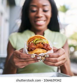 African American Woman Holding Nashville Hot Chicken Sandwich