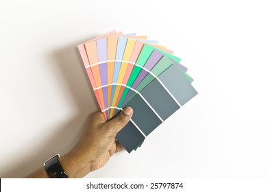 African American Woman Holding A Selection Of Paint Swatches