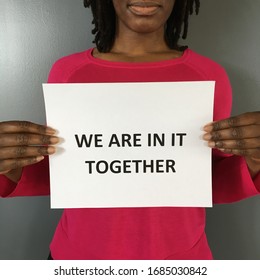 African American Woman Holding Up A Sign Indicating We Are In It Together