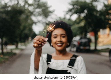 An African American Woman Holding A Sparkler