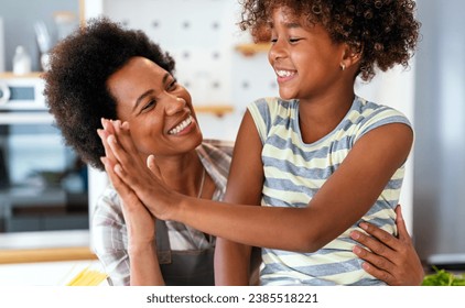 African american woman hugging her smiling teen daughter. Family love single parent child concept - Powered by Shutterstock