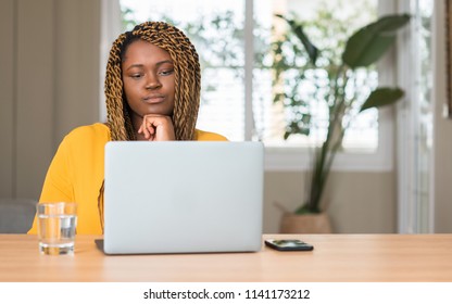 African american woman with laptop serious face thinking about question, very confused idea - Shutterstock ID 1141173212