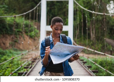 African American Woman Looking At A Map Travel And Explore Concept