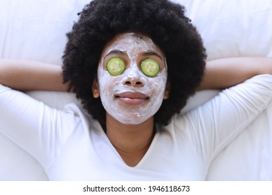 African American Woman Lying In Bed Wearing Beauty Mask. Staying At Home In Isolation During Quarantine Lockdown.