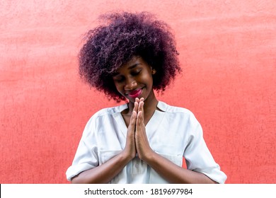 An African American woman makes a gesture of gratitude - Shutterstock ID 1819697984