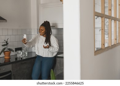 African american woman making video call, in kitchen - social networks and connection - Shutterstock ID 2255846625