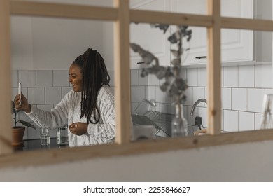 African american woman making video call, in kitchen - social networks and connection - Shutterstock ID 2255846627