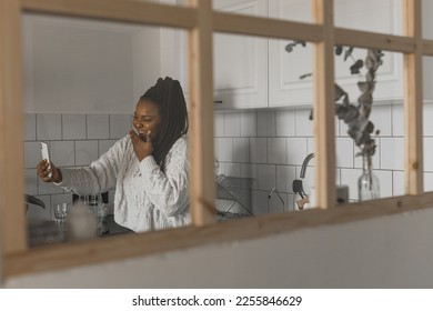 African american woman making video call, in kitchen - social networks and connection - Shutterstock ID 2255846629