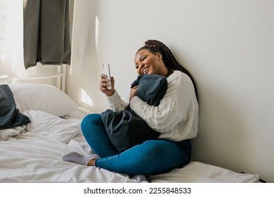 African american woman making video call in bedroom - social networks and connection - Shutterstock ID 2255848533