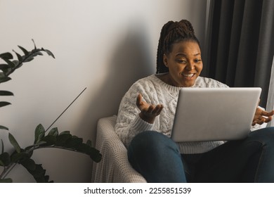 African american woman making video call in living room - social networks and connection - Shutterstock ID 2255851539
