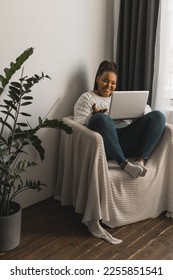 African american woman making video call in living room - social networks and connection - Shutterstock ID 2255851541