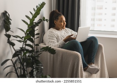 African american woman making video call in living room - social networks and connection - Shutterstock ID 2255851551