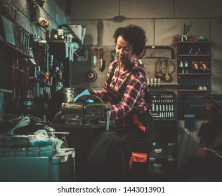 African American Woman Mechanic Polishing Motorcycle Fuel Tank