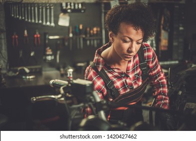 African American Woman Mechanic Repairing A Motorcycle In A Workshop