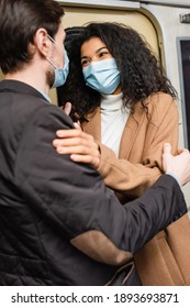 African American Woman In Medical Mask Hugging With Boyfriend In Subway