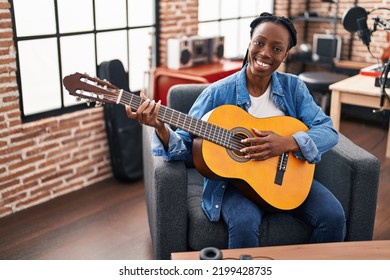 African American Woman Musician Playing Classical Guitar At Music Studio