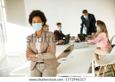 African American woman in the office wear mask as protection from corona virus