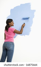 African American Woman Painting Wall Blue.