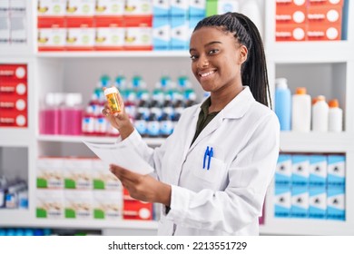 African American Woman Pharmacist Reading Prescription Holding Pills Bottle At Pharmacy