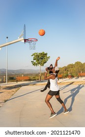 African American Woman Playing Basketball With Her Black Dog.