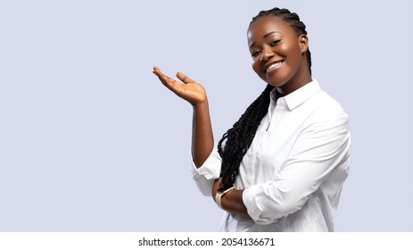 African American woman pointing both hands on upper side with smiling face. Smiling beautiful professional business African American black woman showing empty copy space on white background - Powered by Shutterstock