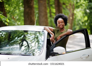 African American Woman Posed Against White Car In Forest Road.