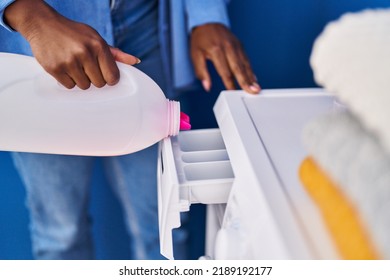 African American Woman Pouring Detergent On Washing Machine At Laundry Room