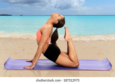 African American woman practicing yoga on the beach - Powered by Shutterstock