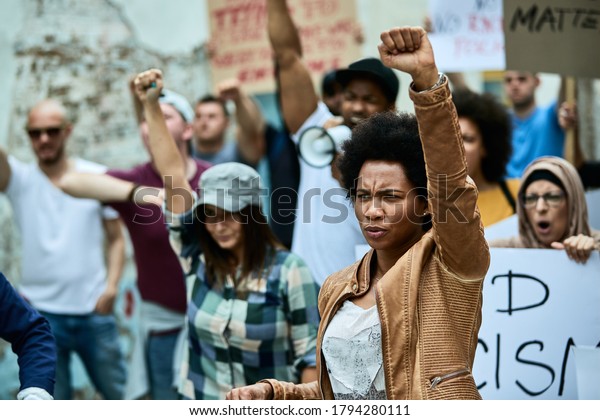 African American woman with raised fist participating in black civil