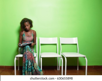 African American Woman Reading Magazine In Waiting Room Of Doctor