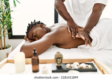 African american woman reciving back massage at the clinic. - Powered by Shutterstock