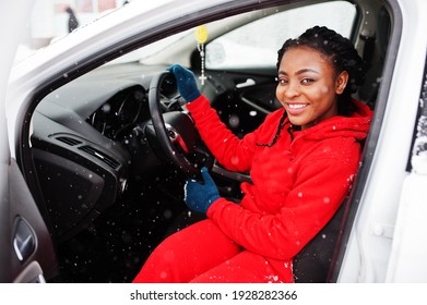 African American Woman In Red Hoodie Sitting Inside Car At Winter Snowy Day.