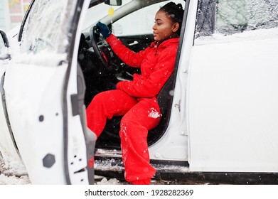 African American Woman In Red Hoodie Sitting Inside Car At Winter Snowy Day.