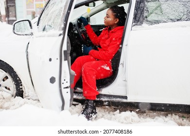 African American Woman In Red Hoodie Sitting Inside Car At Winter Snowy Day.