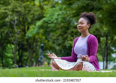 African American Woman Relaxingly Practicing Meditation In The Forest To Attain Happiness From Inner Peace Wisdom For Healthy Mind And Soul Concept