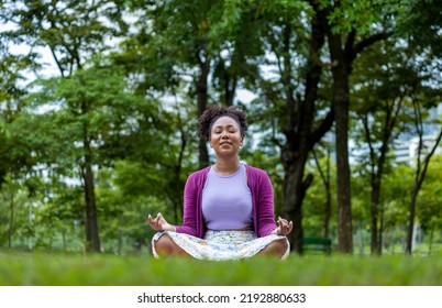 African American Woman Relaxingly Practicing Meditation In The Forest To Attain Happiness From Inner Peace Wisdom For Healthy Mind And Soul Concept