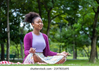 African American Woman Relaxingly Practicing Meditation In The Forest To Attain Happiness From Inner Peace Wisdom For Healthy Mind And Soul