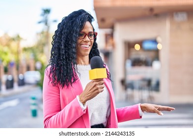 African American Woman Reporter Working Using Microphone At Street