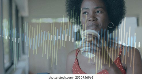 African American woman reviews data on a transparent screen, with copy space. She analyzes information in a modern office setting. - Powered by Shutterstock