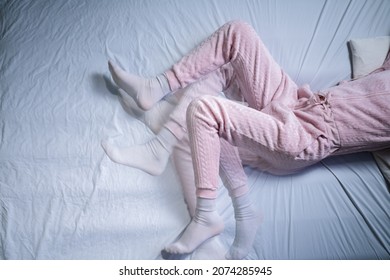 African American Woman With RLS - Restless Legs Syndrome. Sleeping In Bed