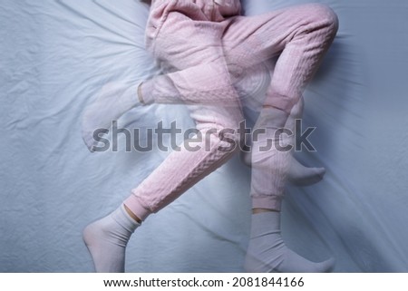 African American Woman With RLS - Restless Legs Syndrome. Sleeping In Bed