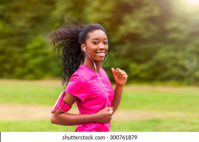 African american woman runner jogging outdoors - Fitness, people and healthy lifestyle