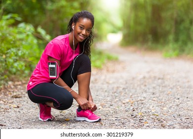 African American Woman Runner Tightening Shoe Lace - Fitness, People And Healthy Lifestyle