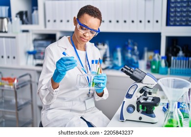 African American Woman Scientist Holding Test Tubes At Laboratory